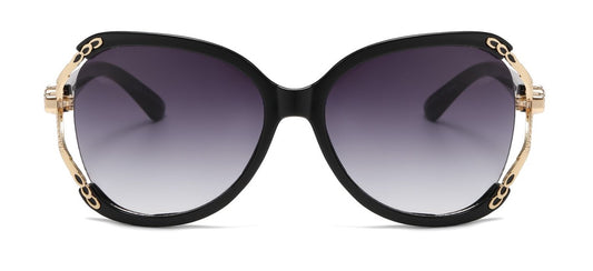 Black sunglasses with gold accents on a white background