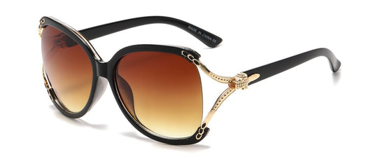 Sunglasses with black frame and brown gradient lenses on a white background
